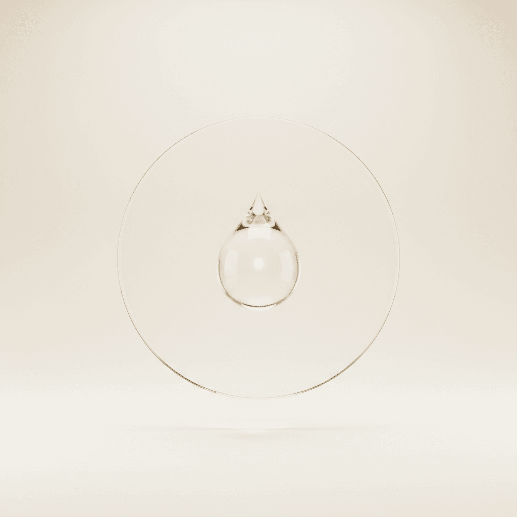 A glass dome with a small glowing droplet inside a clear ring